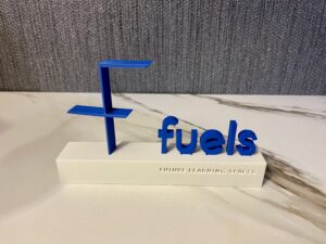 3D-Modell des fuels Logos in blau auf weißem Podest.